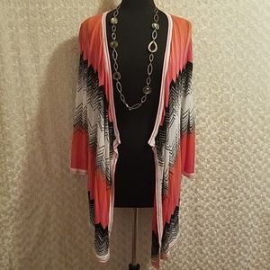 Red brand rusty pink, black, and white sweater